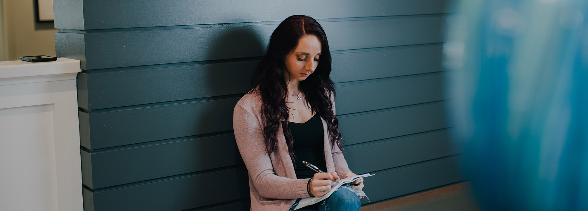 A patient writing in a journal dealing with PTSD and substance use 