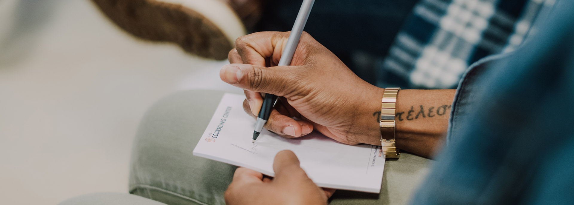 a man writing notes in a group session at 