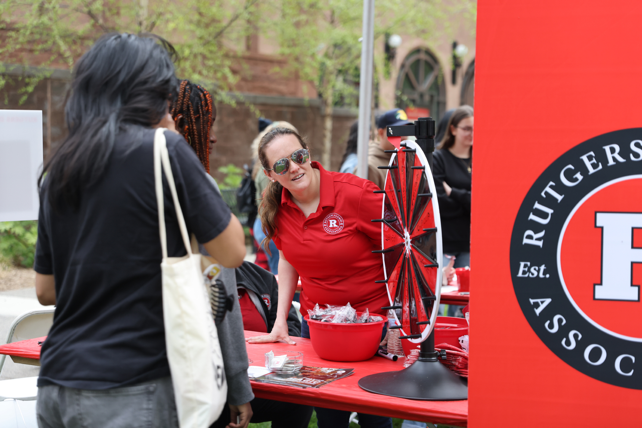 Attendees stop at a program table on Rutgers Day