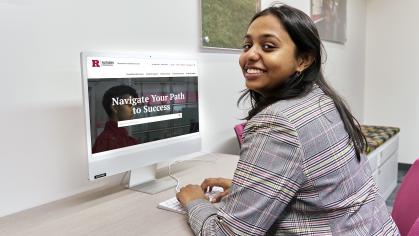 Student sitting at a desk with a computer with the Success website on the screen