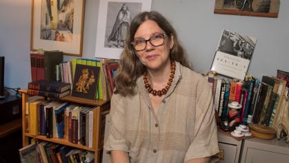 Camilla Townsend sitting on front of bookshelves filled with books