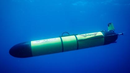 A yellow underwater robot seems to float underwater