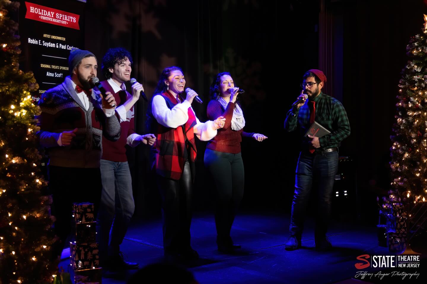 May be an image of standing, christmas tree, microphone, night and text