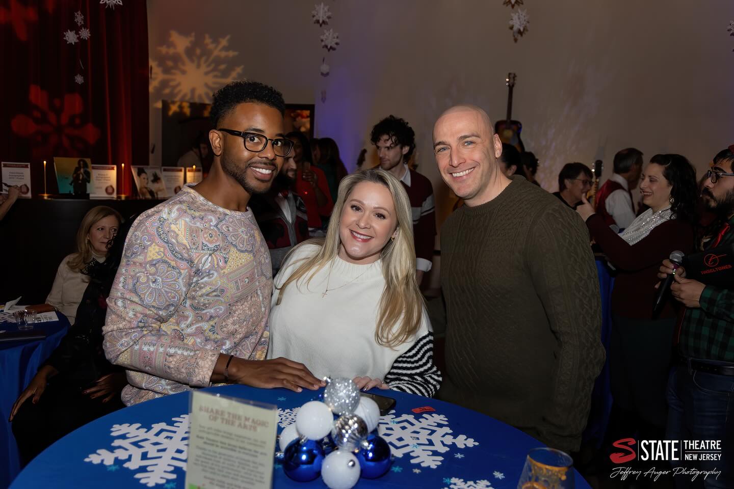 May be an image of one or more people, christmas tree, sweater, tinsel and text