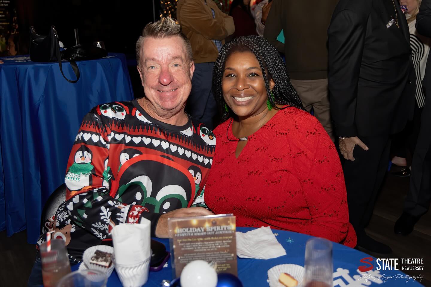 May be an image of one or more people, sweater, snowman and text