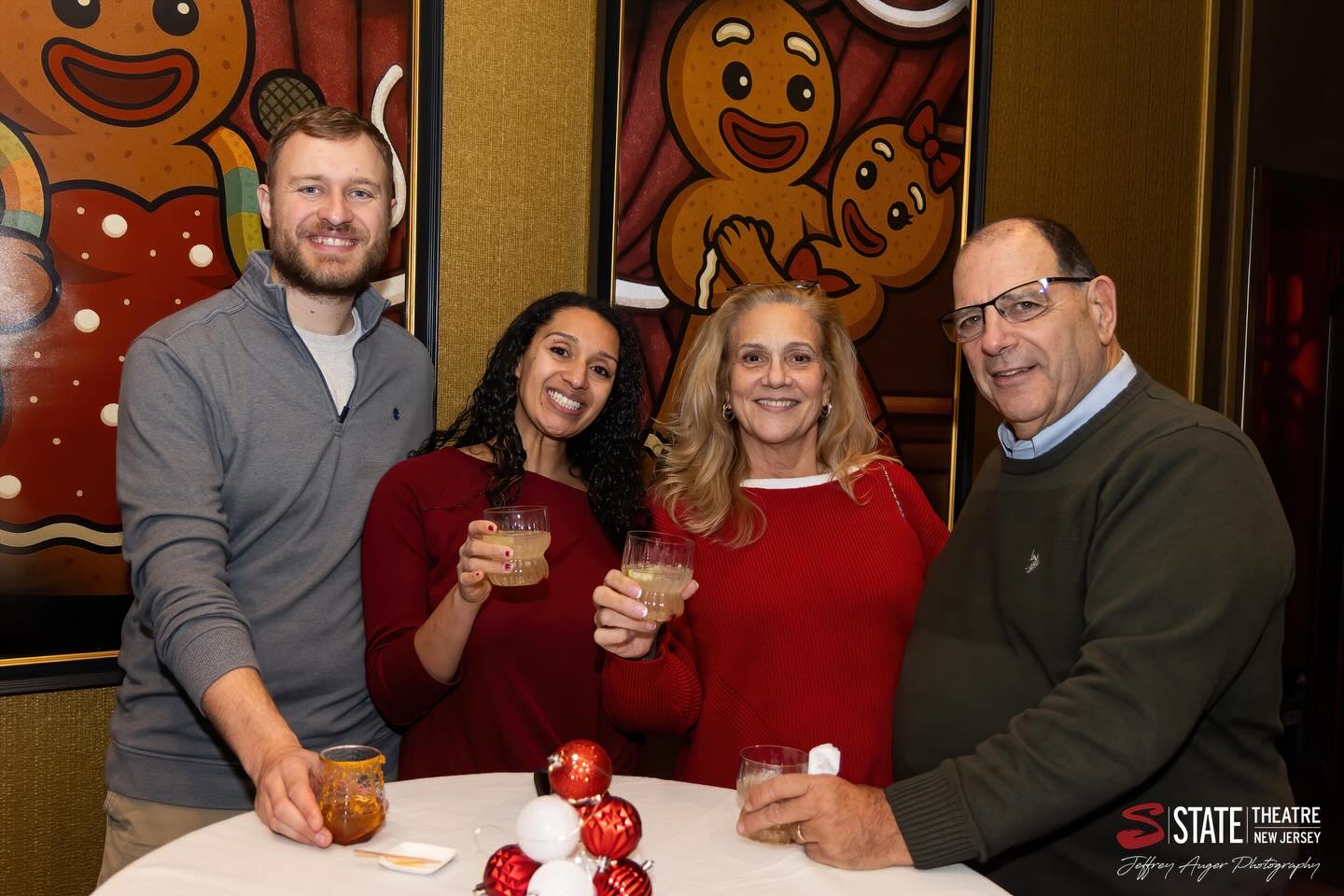 May be an image of gingerbread cookie, drink, sweater and text