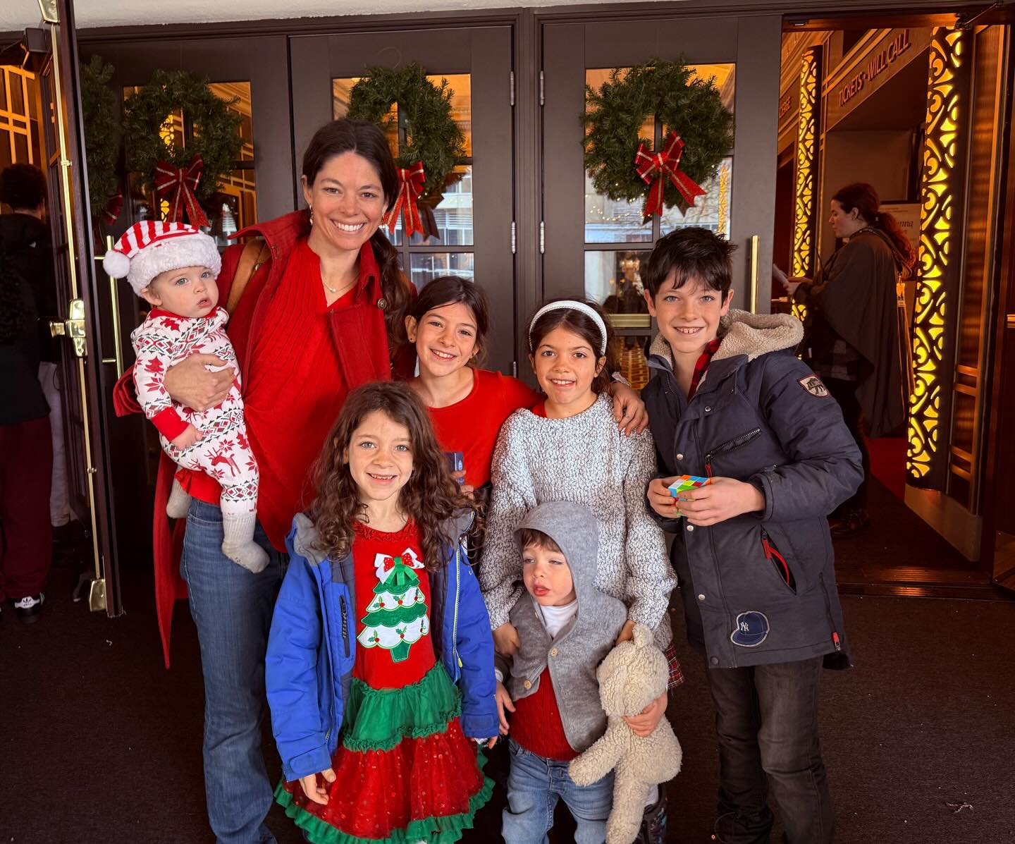 May be an image of standing, christmas tree, tinsel and text