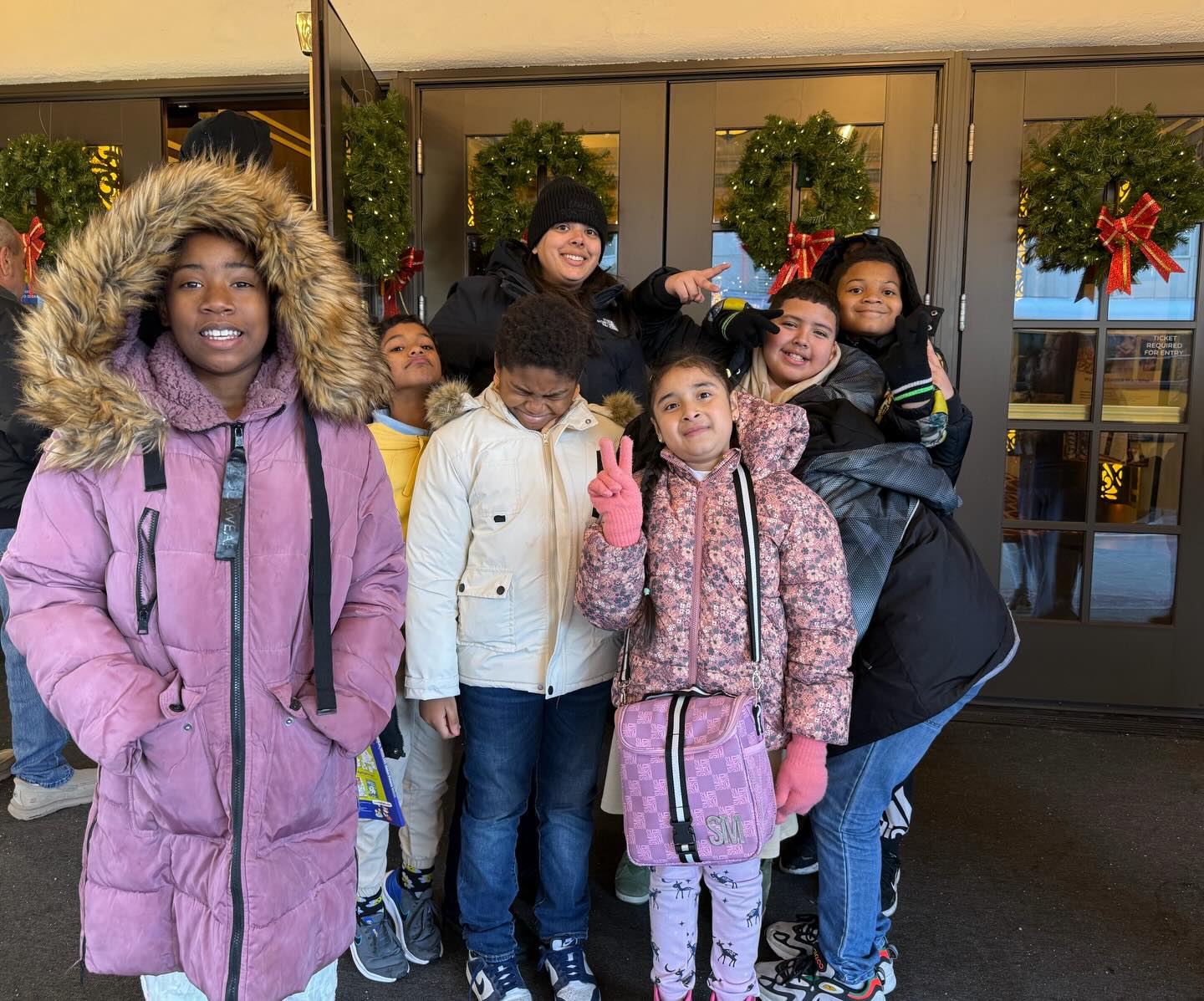 May be an image of child, smiling, standing, fleece, snowsuit, tree and text