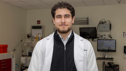 Omar M. Abuattieh stands in a lab room in the Ernest Mario School of Pharmacy.