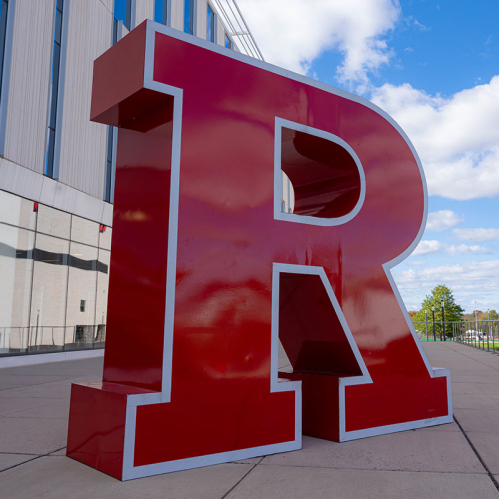 R Logo sculpture under a bright blue fall sky