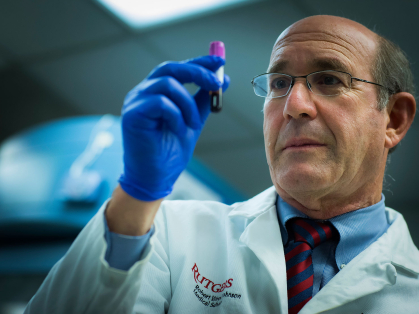 Jeffrey Carson examines blood vial