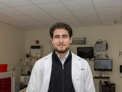 Omar M. Abuattieh stands in a lab room in the Ernest Mario School of Pharmacy.