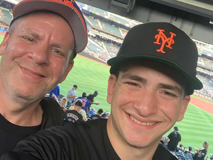 Rutgers-New Brunswick student Tommy Kelson (right) takes a photo with his dad Glenn Kelson during a New York Mets game at Citi Field on Aug. 5, 2022.