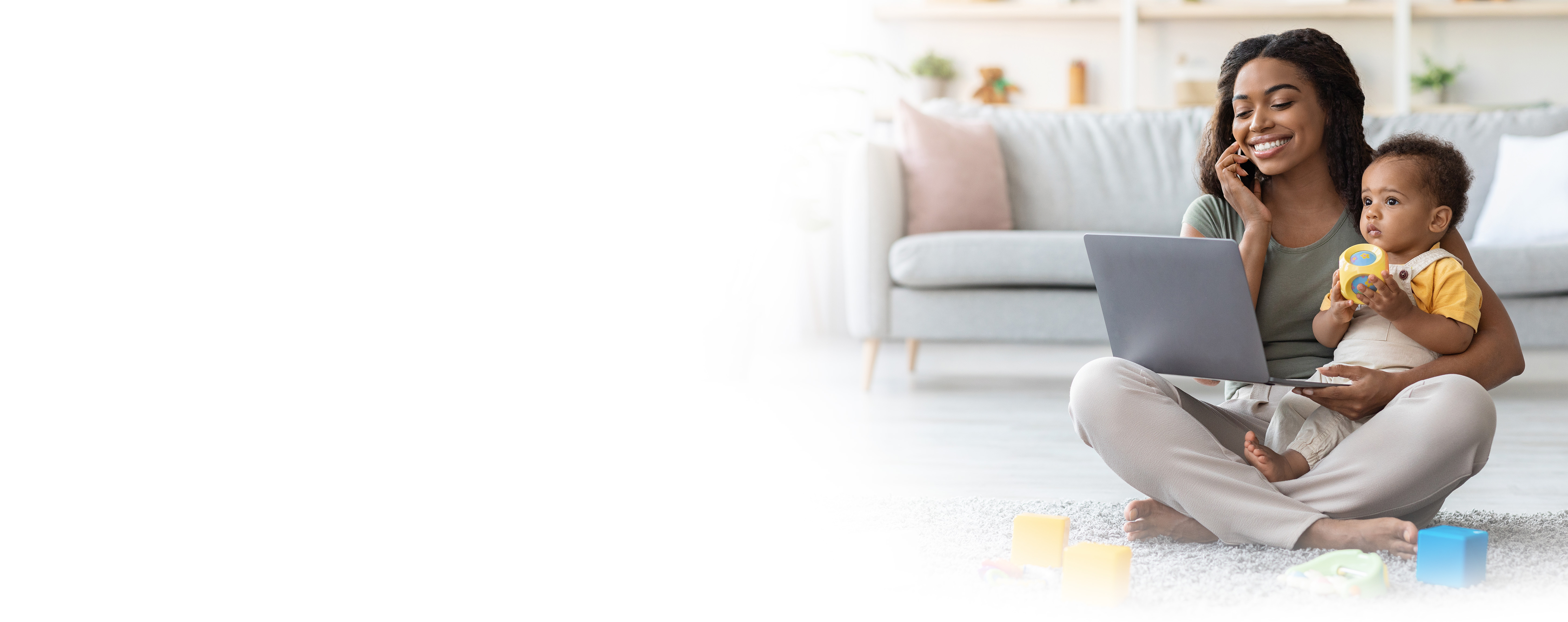 Woman sitting on floor holding baby