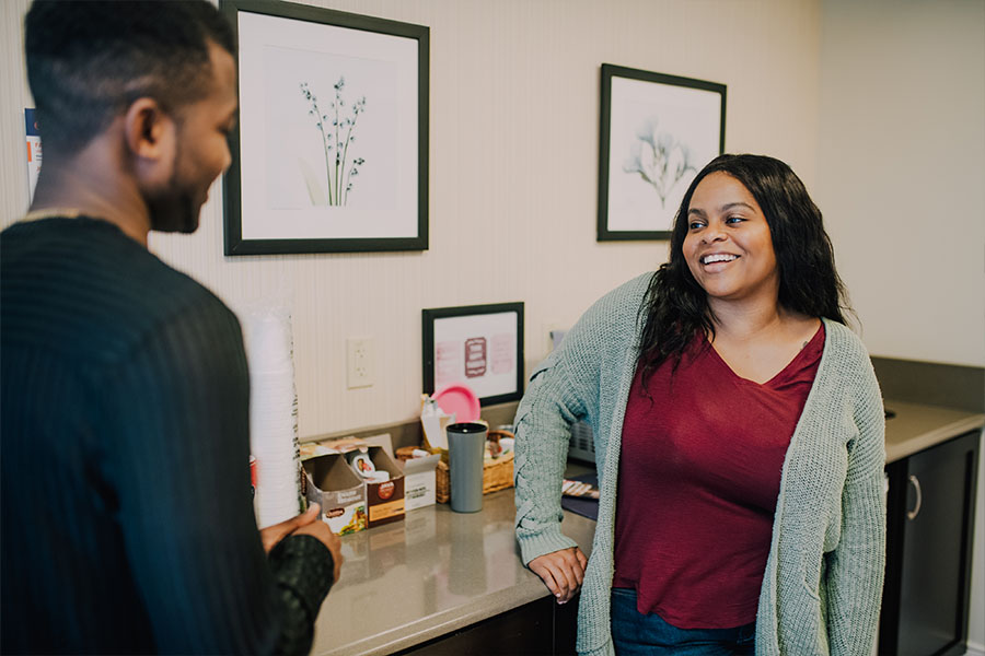 Two patients chatting in the cafe area