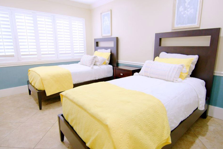 double beds in a patient room with yellow blankets
